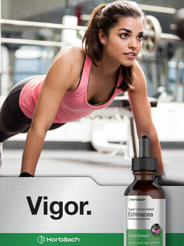View 7 Woman doing push-ups in a gym with a bottle of echinacea extract in the foreground.