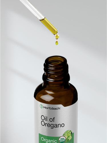 Bottle of Oil of Oregano with dropper on a light background