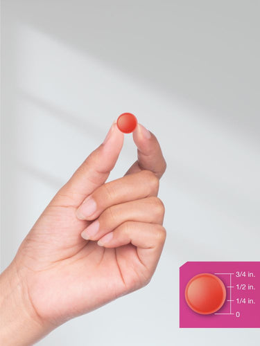 View 8 Small red circular object held between fingers with size measurement inset.