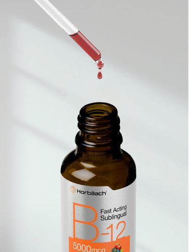 View 8 Brown bottle labeled 'B-12' with dropper dispensing liquid on a light background.