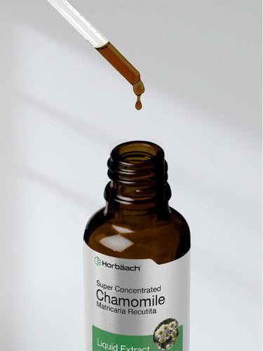Brown bottle labeled 'Super Concentrated Chamomile' with dropper dispensing liquid.