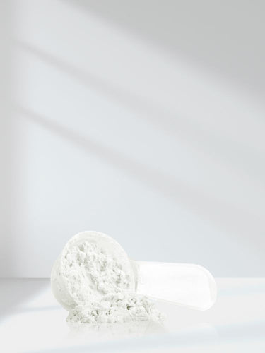 White towel rolled up on a white background