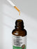 Brown glass bottle of Korean Red Panax Ginseng with dropper on a neutral background