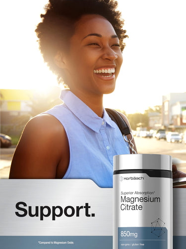 View 6 Young African American woman smiling in sunlight with a Horbaach Magnesium Citrate bottle outdoors.