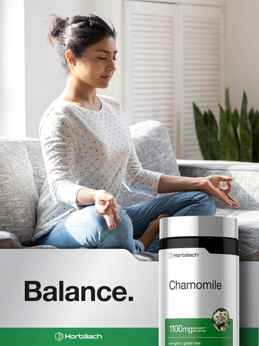 View 6 A young woman meditates on a sofa next to a bottle of Horbäach Chamomile, promoting relaxation.