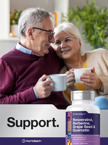 Couple enjoying a cup of tea with a bottle of Herb Bach supplements in the foreground.