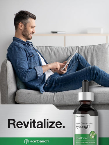 Man sitting on a couch using a tablet with a bottle of Horebaech Eyebright Liquid Extract in the foreground.