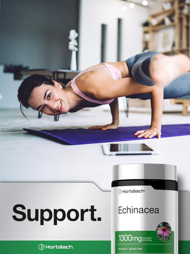 View 6 A young woman smiles while doing a yoga pose on a mat, next to a bottle of Echinacea.
