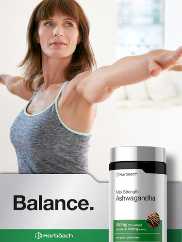 View 6 A middle-aged woman practices yoga with outstretched arms next to a Horbäach Ashwagandha bottle.