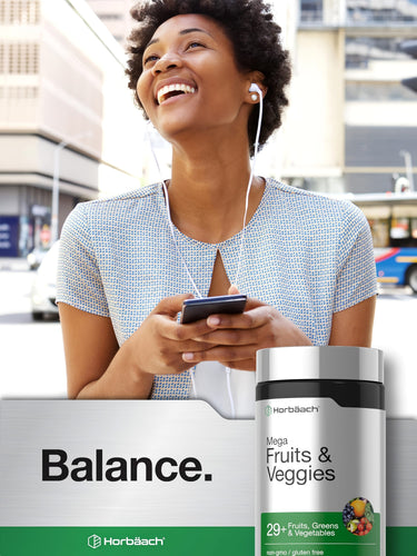 View 6 Woman smiling, listening to music with earbuds, holding a phone, next to a Horbäach Fruits & Veggies bottle.