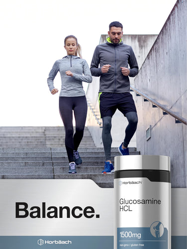 View 6 A young man and woman running up stairs with a bottle of Horbäach Glucosamine HCL.