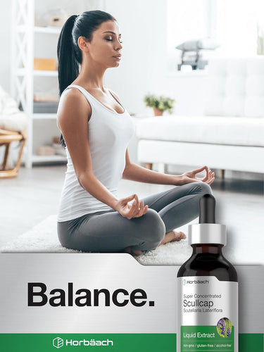 Woman meditating with a bottle of Horbaach Scullcap Liquid Extract on a white background
