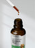 Burdock root tincture bottle with dropper on a white background