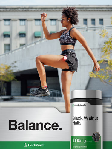 View 12 Lifestyle image of an adult exercising outdoors with Black Walnut Hulls supplement bottle, stating Balance.