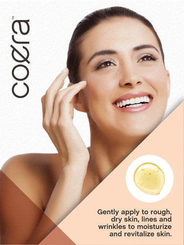 View 14 Lifestyle image of adult touching her face with Coera Vitamin E Oil, with text stating Gently apply to rough, dry skin, lines and wrinkles to moisturize and revitalize skin.