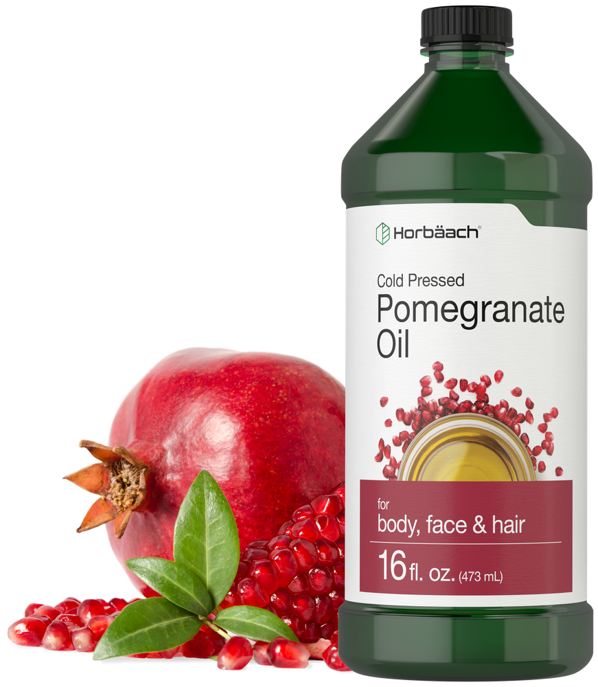 Horbaach Pomegranate Oil bottle with pomegranate fruit and seeds on a white background