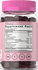Supplement bottle with pink cap and label displaying supplement facts.