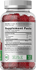 Supplement bottle with red gummies and label details.