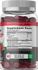 Supplement bottle with red gummies and label