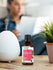 Bottle of Honeysuckle essential oil with a diffuser and plant on a table.