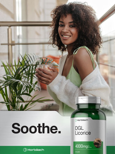 Woman holding a glass of tea with a bottle of DGL Licorice supplement in the foreground.